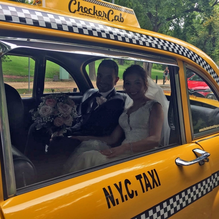 bride and groom in taxi